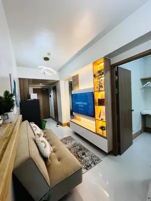 a living room with a large couch and a flat screen tv at Suite 07 MOA GRAND STAY Newly Turn over Only in Manila