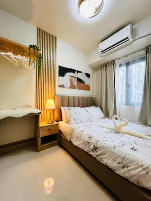 a bedroom with a bed and a window at Suite 07 MOA GRAND STAY Newly Turn over Only in Manila
