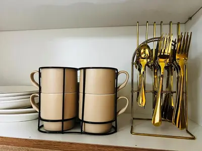 two coffee cups and utensils on a shelf at Suite 07 MOA GRAND STAY Newly Turn over Only in Manila