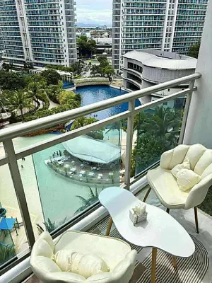 a balcony with chairs and tables and a view of a city at 320 Santorini Staycation in Manila
