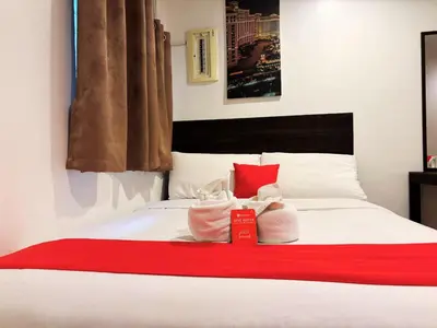 a bedroom with a bed with two towels on it at City Stay Inns Slex Makati in Manila