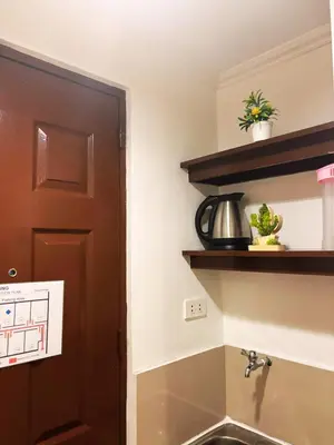 a kitchen with a sink and a brown door at City Stay Inns Slex Makati in Manila