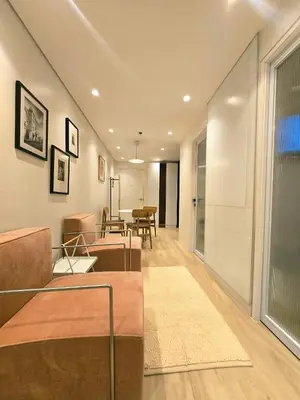 a living room with two beds and a table at Hygge-ParkWest BGC near Grand Hyatt & Mitsukoshi in Manila