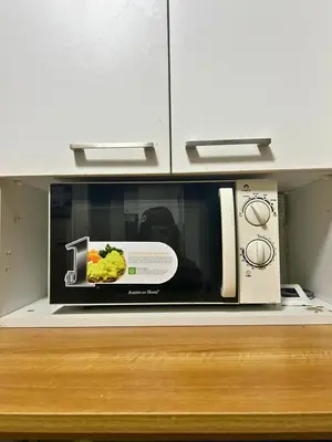 a microwave sitting on top of a kitchen counter at City Comfort Studio at Sunshine 100 in Manila