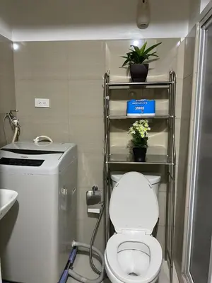 a small bathroom with a toilet and a sink at Shore 2 residences tower 1 in Manila