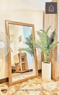 a bathroom with a mirror and a palm plant at The Cozy Home of Calleigh in Allegra in Manila