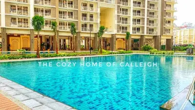 a large swimming pool in front of a building at The Cozy Home of Calleigh in Allegra in Manila