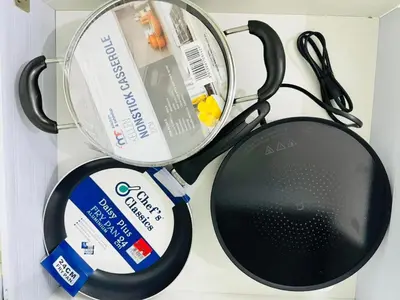 a table topped with a frying pan and a racket at Azure Urban Resort Residences Parañaque City near NAIA Airport in Manila