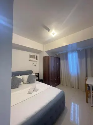 a bedroom with a large bed in a room at 2 Bedroom Shore Residence Mall Of Asia Complex in Manila