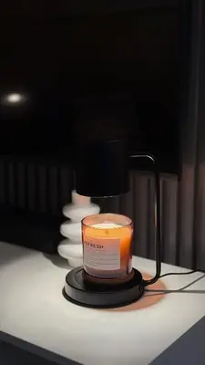 a candle sitting on a table with a lamp at Luxe and Modern 1BR Unit in BGC in Manila