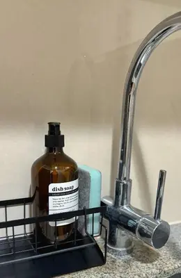 a bottle of dish soap sitting next to a sink at Luxe and Modern 1BR Unit in BGC in Manila