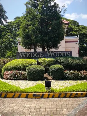 a sign for the widescreen woods sign in front of a building at Prime Zen in Silang