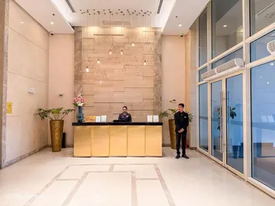 two men standing at a desk in a lobby at Cozy and Spacious Fast WiFi FREE Access Pool and Gym in Manila