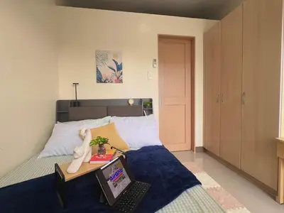 a bedroom with a bed with a laptop on it at 1 Bedroom Condo Unit Near SM City Sucat and NAIA Terminal in Manila
