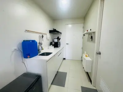 a small white kitchen with a sink and a toilet at Semi Furnished Condo at Sta Rosa Zadia Tower 2 in Sampong