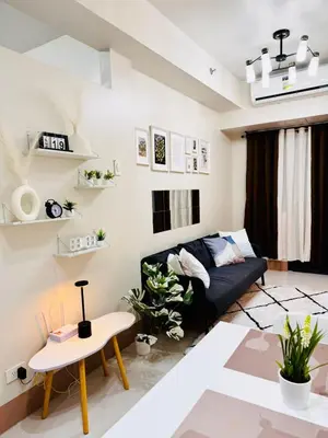 a living room with a couch and a table at AR Pahinga Place - The Pause House in Manila
