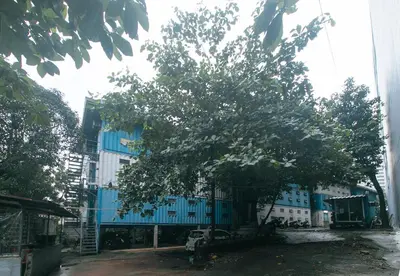 a tree in front of a blue building at CitiHub Shaw Santa Mesa in Manila