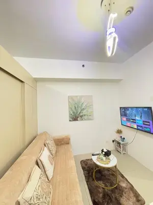 a living room with a couch and a table at Jazz Luxe Getaway in Manila