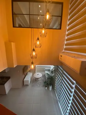 a bathroom with yellow walls and a toilet and lights at EDSA Heights Penthouse Unit 3306 Ama Tower Residences in Manila