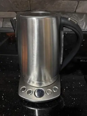 a silver coffee pot on a stove at Kaizen cozy and comfortable condo at Red Residences Makati in Manila