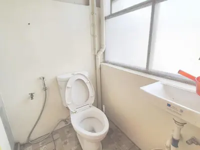 a bathroom with a toilet and a sink and a window at Nemar Building Solo Room w AC in Manila