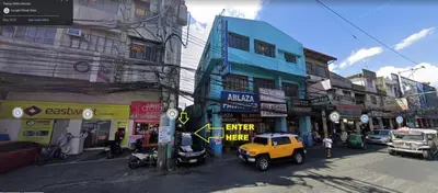 a street with buildings and a yellow jeep parked on the street at Nemar Building Solo Room w AC in Manila