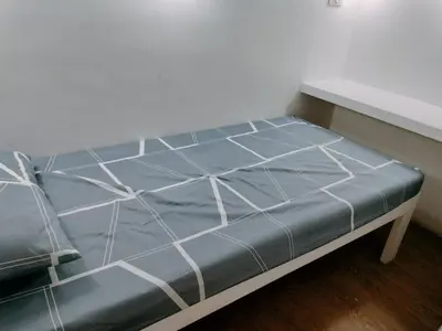a bed in a room with a blue mattress at Nemar Building Solo Room w AC in Manila