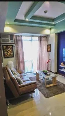 a living room with a couch and a coffee table at 1 BR Luxury Apartment in Manila