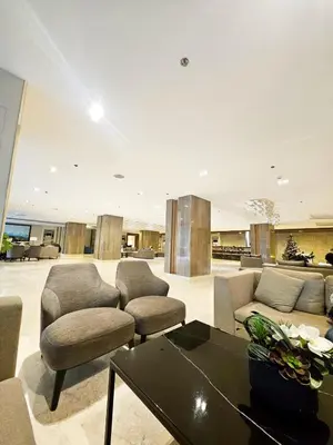 a living room with a couch and chairs and a table at Cozy Modern Condotel in Pasay Near MOA & Airport in Manila