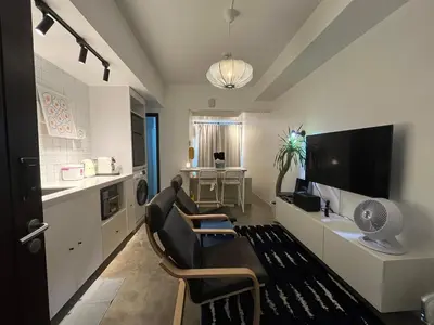 a living room with a couch and chairs and a tv at San Lorenzo Place Condominium Makati City in Manila