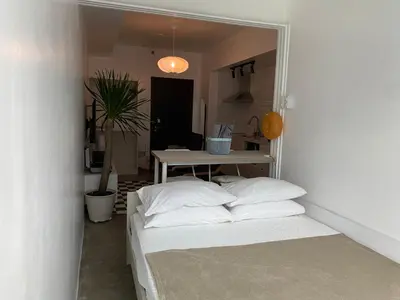 a room with two beds and a table in it at San Lorenzo Place Condominium Makati City in Manila