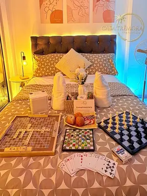 a bed with a chess board on top of it at Azure Staycation by Casa Tremora in Manila
