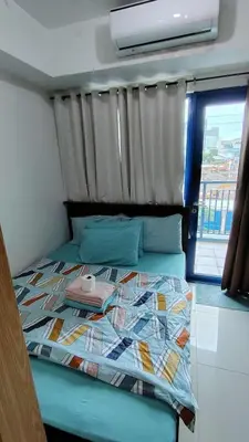 a bed in a room with a window at Sea Residence Condotel Pasay in Manila