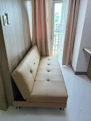 a white couch in a room with a window at Cozy Minimalist Staycation in Manila