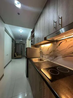 a kitchen with a sink and a counter top at Cozy Minimalist Staycation in Manila