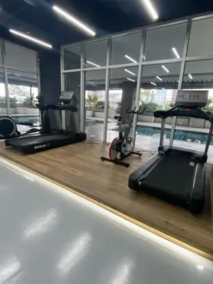a gym with two treadmills and two exercise bikes at EDSA Heights Ama Tower Unit 3305 Loft Penthouse Unit in Manila