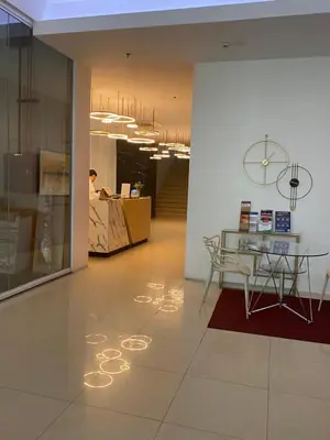 a lobby with a table and a desk in a building at EDSA Heights Ama Tower Unit 3305 Loft Penthouse Unit in Manila