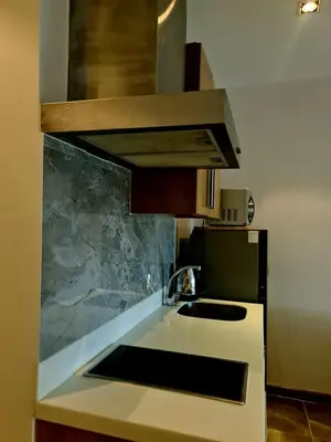 a kitchen with a sink and a microwave at Condominium unit Knightsbridge Residences, Makati in Manila