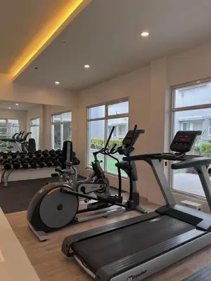 a gym with two treadmills and a treadmill at Staycation at JG in Manila
