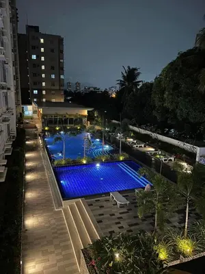 a swimming pool with blue lights on top of a building at Staycation at JG in Manila
