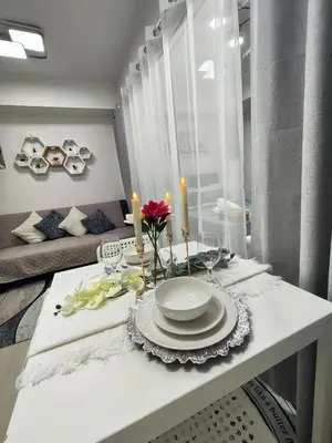 a dining table with plates and candles on it at City Escape in Manila