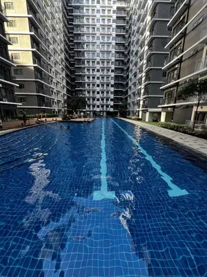 a large swimming pool with tall buildings in the background at MOA GRAND STAY Suite 02 Newly Turn-over Only in Manila