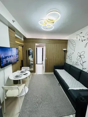 a living room with a couch and a table at MOA GRAND STAY Suite 03 Spacious Unit ! in Manila