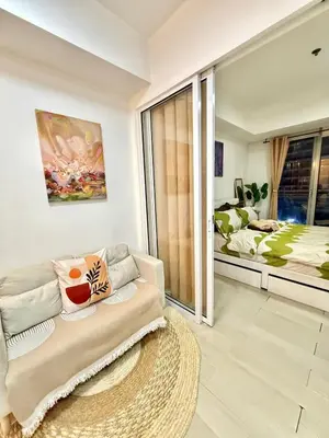 a living room with a couch and a bed at Staycation in Casitas in Manila