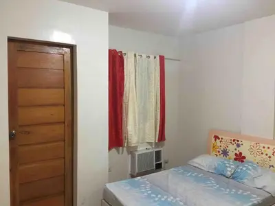 a small bedroom with a bed and a window at Furnished 2BR Apartment in Paradahan