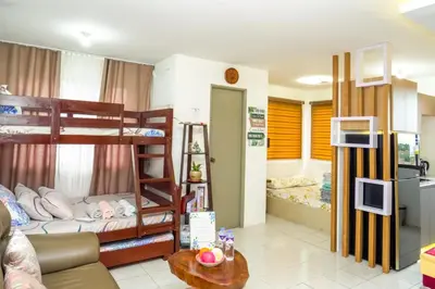 a room with two bunk beds and a living room at Serene City Abode in Santa Rosa