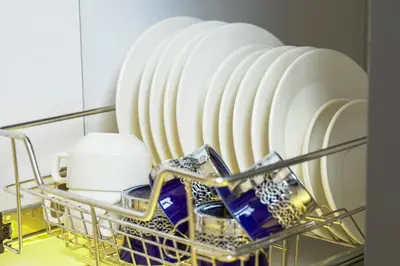 a rack of white plates on a shelf at Serene City Abode in Santa Rosa
