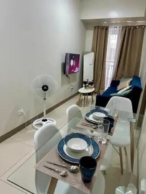 a living room with a dining table and chairs at Simple Stays at S Residence Pasay in Manila