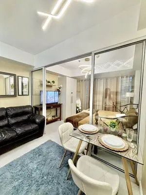 a living room with a table and chairs and a couch at Staycation in Casa Joaquin in Manila