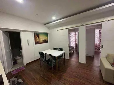 a living room with a table and chairs and a couch at Staycation in Casa Joaquin in Manila
